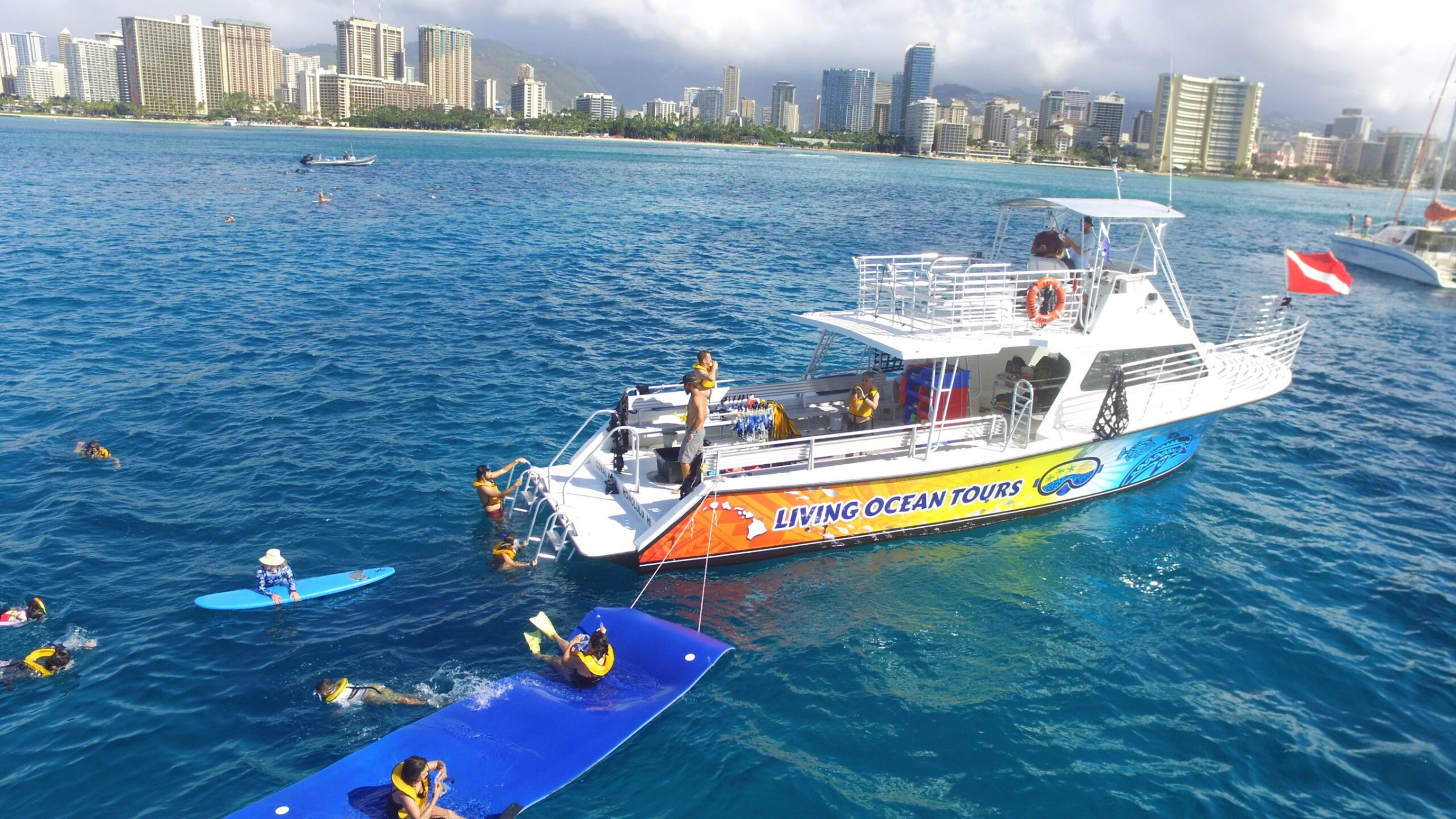 a small boat in a body of water with a city in the background